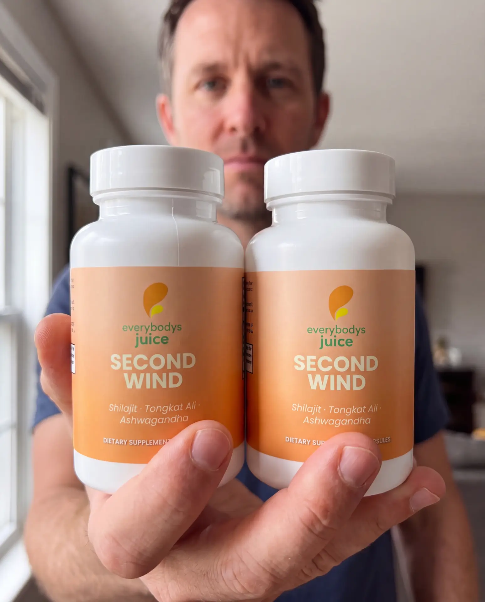 Customer holding two bottles of Second Wind